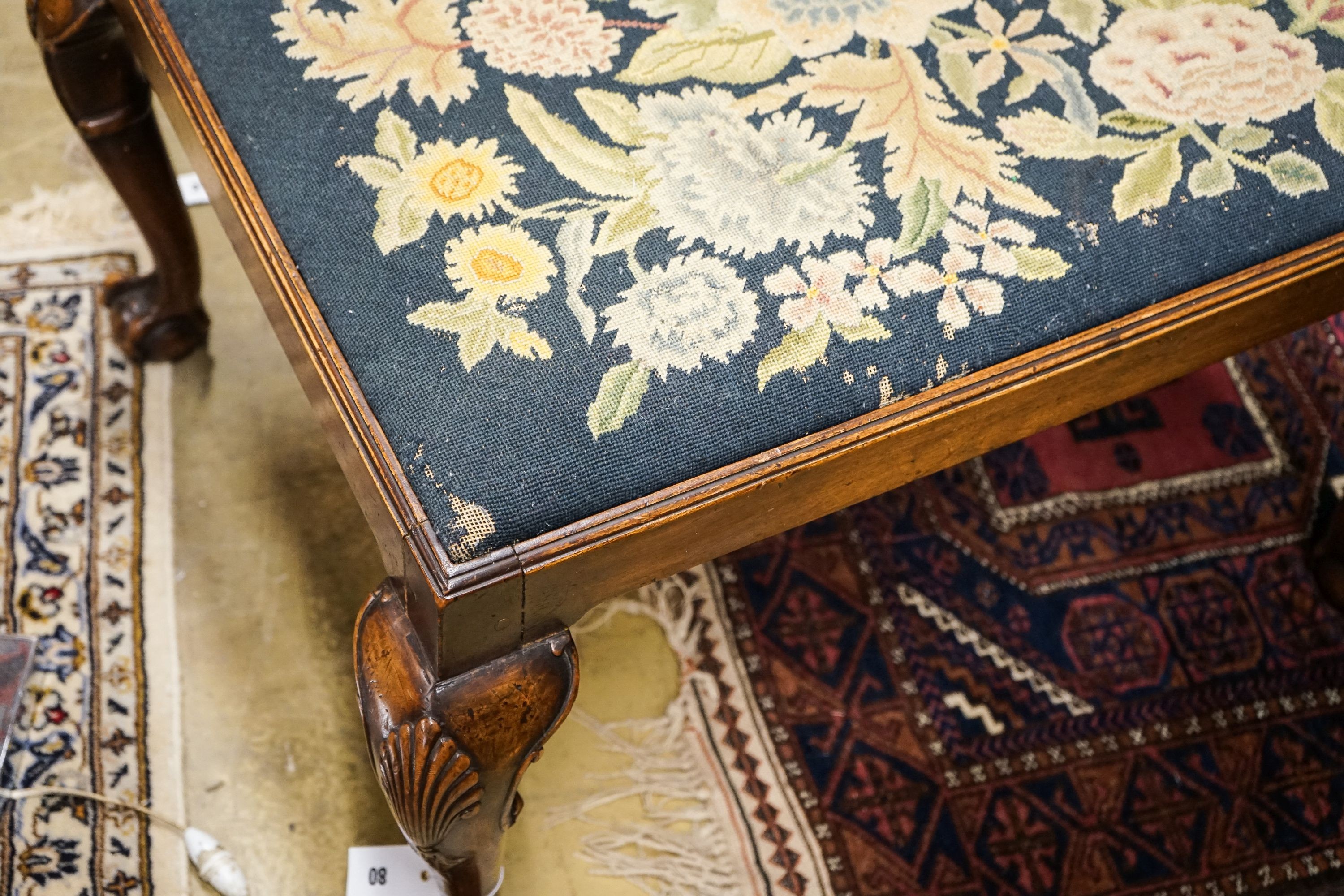 A George III style mahogany stool with drop in tapestry seat on ball and claw feet, signed JS 1927, length 76cm, depth 66cm, height 46cm